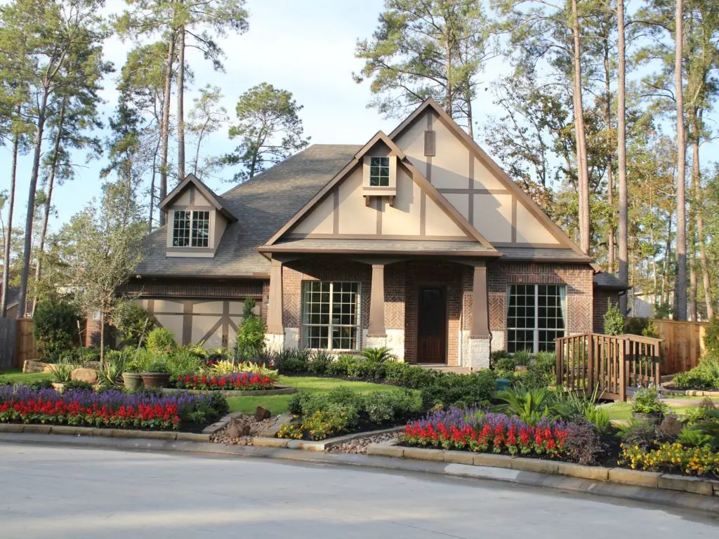 Custom residential landscape installed by PGS — Tudor home with manicured beds